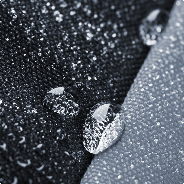 a closeup shot of a coverland car cover showing the sturdy materials against rain droplets