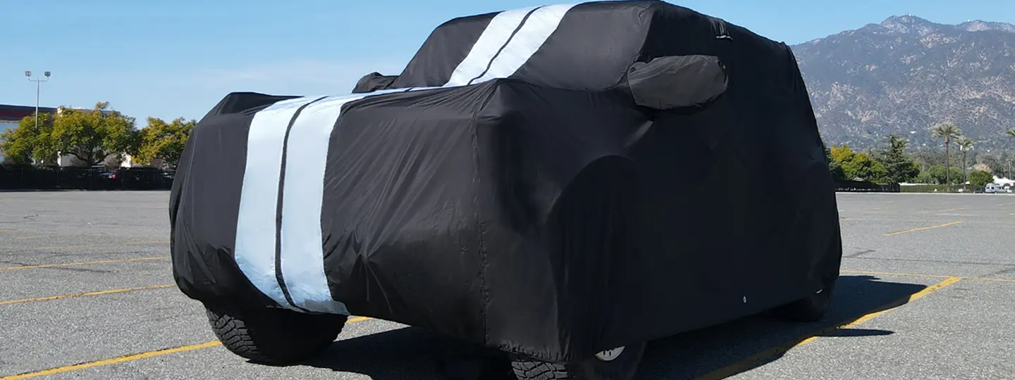 Sedan car covered with Coverland car cover in rain